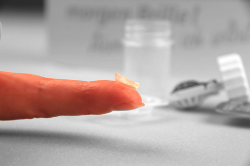 Kontaktlinsen auf Finger